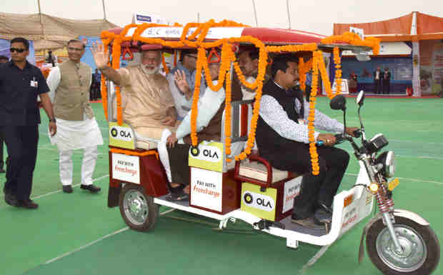 Narendra Modi taking a ride on e-Rickshaw, on the launch of 'Stand up India' programme, in Noida, Uttar Pradesh on April 05, 2016