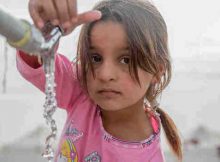On 15 November, a young girl from Mosul takes water from a tap stand at a UNICEF-supported Temporary Learning Space in Hassan Sham Displacement Camp, Ninewa Governorate. “I like it here because we’ve been out of school for two years,” she said. Photo: UNICEF