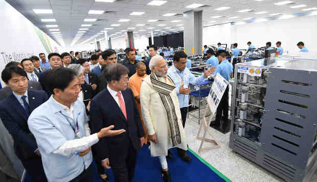 The Prime Minister, Narendra Modi and the President of the Republic of Korea, Moon Jae-in taking a tour of mobile factory in Noida, Uttar Pradesh on July 09, 2018