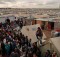 Syrian refugees crowd around an office in Domiz refugee camp in the Kurdistan Region of Iraq. Photo: OCHA