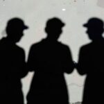 Shadows of anonymous individuals representing hidden digital threats and illicit ad markets.