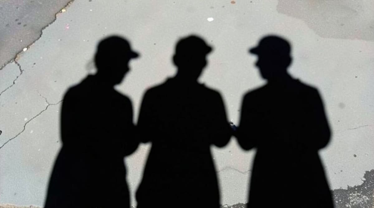 Shadows of anonymous individuals representing hidden digital threats and illicit ad markets.